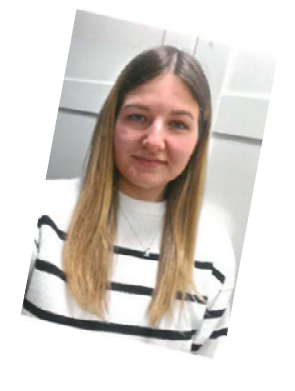 Elisabeth Treutz, new team member, smiling in a striped sweater.